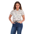 A woman modelling a cream Wrangler Women's Heidi Short Sleeve Shirt (X6S2102610) with a western novelty print, paired with blue jeans and a stone coloured Wrangler Zola Belt (XCP2918BLT), against a plain white background.