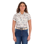 A woman modelling a cream Wrangler Women's Heidi Short Sleeve Shirt (X6S2102610) with a western novelty print, paired with blue jeans and a stone coloured Wrangler Zola Belt (XCP2918BLT), against a plain white background.