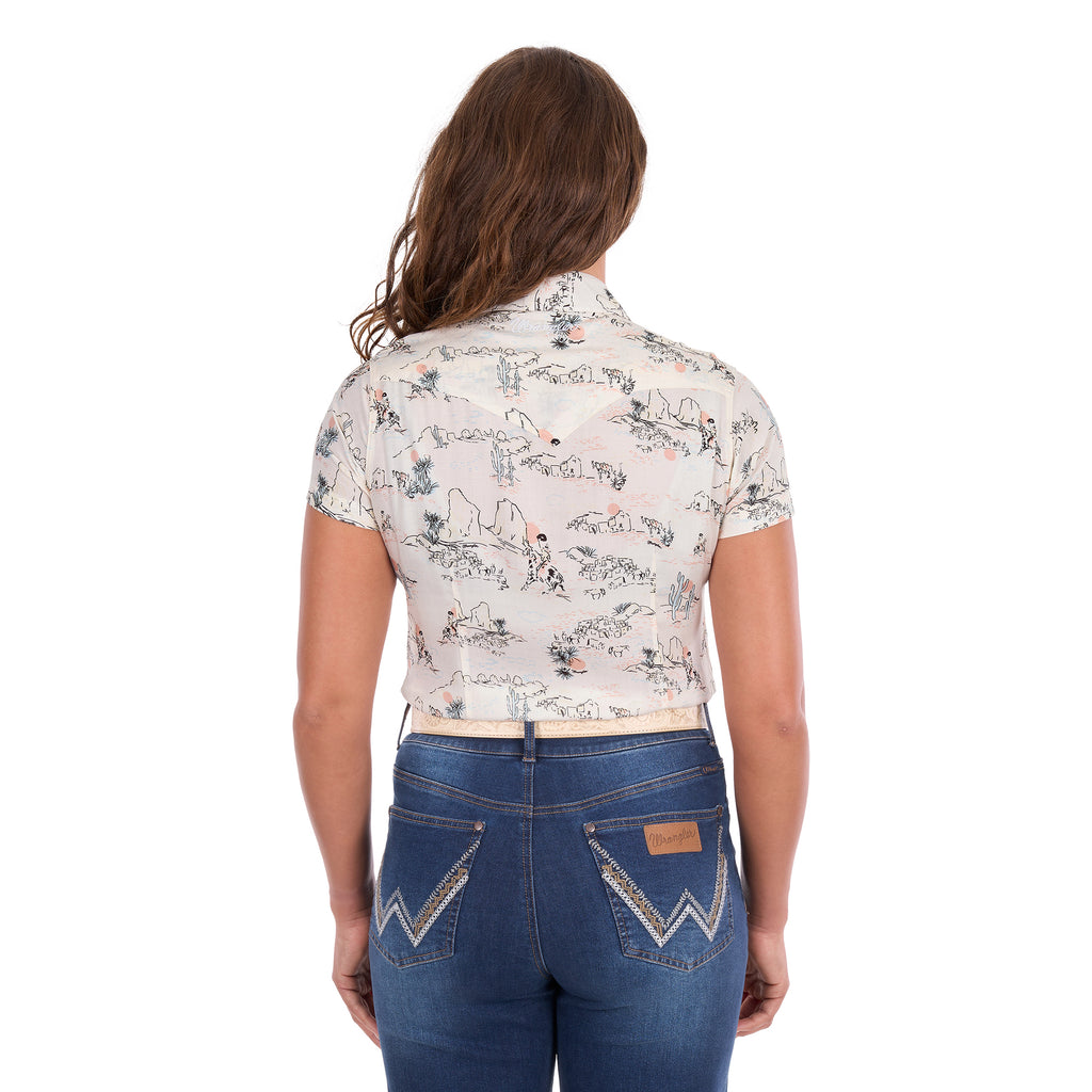 A woman viewed from behind, modelling a cream Wrangler Women's Heidi Short Sleeve Shirt (X6S2102610) with a western novelty print, paired with blue jeans and a stone coloured Wrangler Zola Belt (XCP2918BLT), against a plain white background.