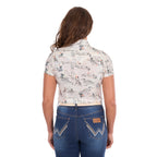 A woman viewed from behind, modelling a cream Wrangler Women's Heidi Short Sleeve Shirt (X6S2102610) with a western novelty print, paired with blue jeans and a stone coloured Wrangler Zola Belt (XCP2918BLT), against a plain white background.