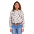A woman modelling a cream Wrangler Women's Ivory Long Sleeve Shirt (X6S2103602) with a western novelty print paired with kora blue Wrangler Women's Margo Trouser Jeans Willow (XCP2253710) and a Wrangler Silvie Belt (X6S2920BLT), against a plain white studio background.