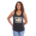 A woman modelling a charcoal Wrangler Women's Jasmine Tank (X6S2508648) with racerback, featuring 'Wrangler Country Girl' graphic on the front, paired with light blue jeans, against a plain white background.