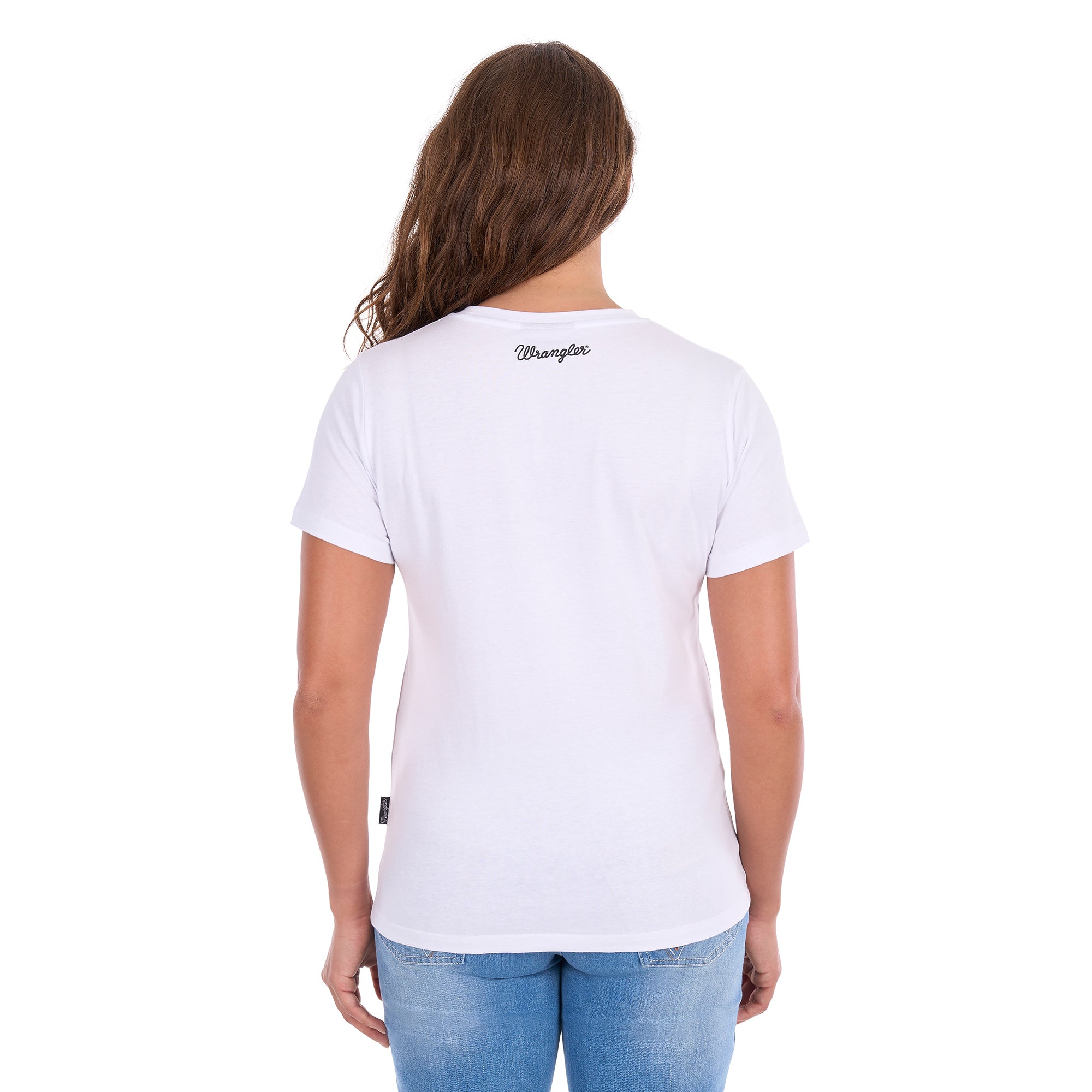 Back view of a woman modelling a white graphic Wrangler Women's Josie Short Sleeve T-Shirt (XCP2598641) with a back neck Wrangler script logo, paired with blue jeans against a plain white background.
