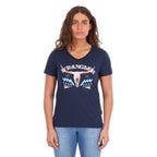 A woman modelling a navy blue Wrangler Women's Lana V-Neck T-Shirt (X6S2599634) with a western graphic on the chest, paired with light blue jeans, against a plain white background.