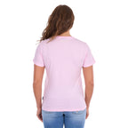 A woman viewed from the back wearing a pastel pink Wrangler Women's Lucy Short Sleeved t-shirt (XCP2598633) and blue jeans, set against a plain white background.