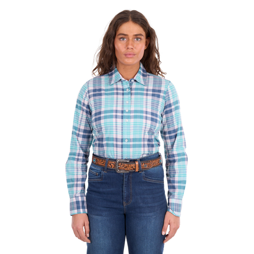 A woman modelling a pink and teal Wrangler Women's Luisa Long Sleeve Shirt (X6S2100607), paired with blue jeans and a tan Wrangler Siara Western Belt (X6S2916BLT), against a plain white background.