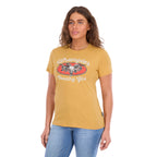 A woman modelling a sunset yellow Wrangler Women's Macie Tee (X6S2598637) with a 'Wrangler Country Girl' graphic worn with blue jeans, set against a plain white background.
