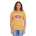 A woman modelling a sunset yellow Wrangler Women's Macie Tee (X6S2598637) with a 'Wrangler Country Girl' graphic worn with blue jeans, set against a plain white background.