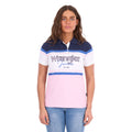 A woman modelling a Pink and Navy Wrangler Women's Maeve S/S Polo (X6S2513627) with a colour-blocked design in navy blue, white, and light pink, paired with blue jeans against a plain white background.