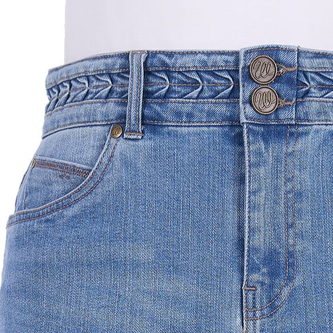 Close-up of the faded blue Wrangler Women's Maisy Denim Skirt (XCP2409723) showing the waistband with braided detailing, double button closure, belt loops, and front pocket with W embroidery.