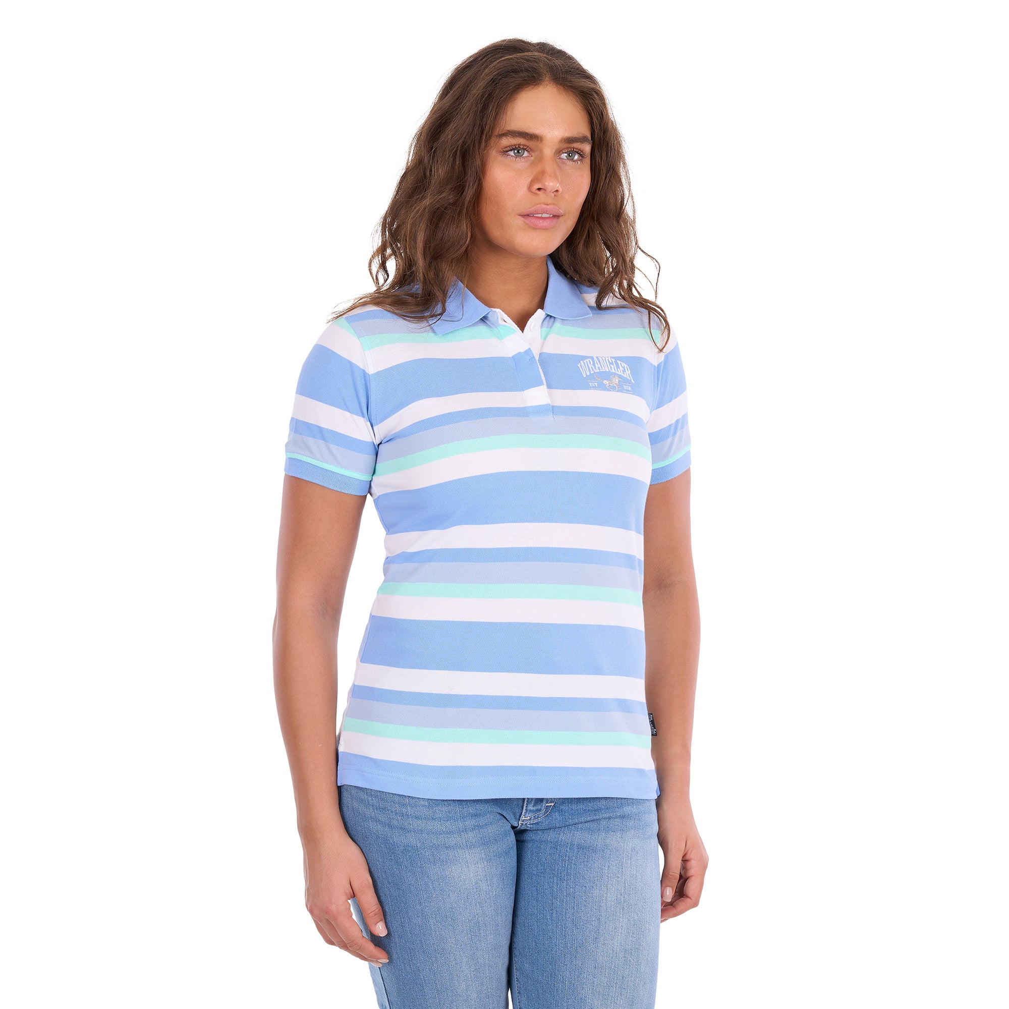 A woman modelling a Wrangler Women's Sloan Short Sleeved Polo Shirt (X6S2514625) with horizontal light blue, white, and pale mint stripes, paired with blue jeans against a plain white background.